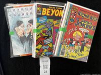 Three bagged comic books strapped together: Kabuki: Reflections, Tales From Beyond, Richie Rich and Jackie Jokers