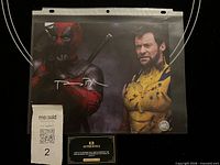 Front view of signed photo in sleeve with autograph visible and COA card