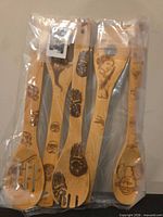 Front view of all five bamboo utensils sealed in plastic