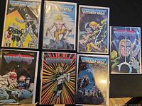 Seven Dragon Force comics laid out, all bagged and sleeved