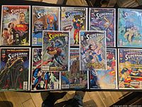 All 12 bagged Superman comics laid out