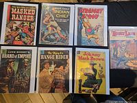All seven bagged Western comics laid out on table