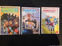 Front covers of all three bagged comics