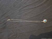 Full view of sterling silver necklace with turquoise pendant