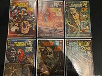 Six bagged The Twilight Zone Gold Key comic books laid out