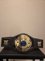 Full front view of WWF toy championship belt on stand