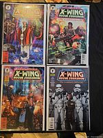 All four bagged comic issues laid out front covers visible