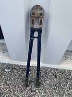 Full view of 30" bolt cutters leaning against wall