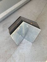 Stack of L-shaped galvanized steel flashing pieces