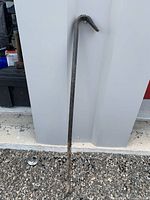 Full view of crowbar leaning against wall