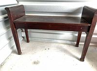 Full view of antique wooden piano bench front