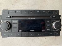 Front view of Chrysler radio showing controls, knobs and display