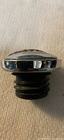 Side view of chrome cap showing domed profile and threaded rubber insert