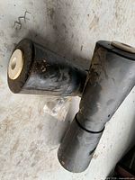 Top view of three black keel rollers showing white nylon sleeves