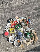 overview of entire mixed hardware and tools pile on asphalt surface