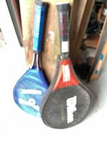 Wilson and Mitre rackets leaning together