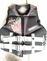 Front view of black Speedo life jacket with floral design and buckles visible