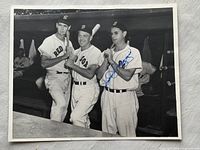 Front view of signed photo showing three players and autograph
