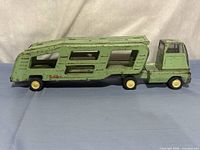 Full left side view of green Tonka car hauler truck