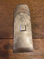 Front of plane blade showing bevel and patina