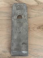 Front view of plane blade with chip breaker attached