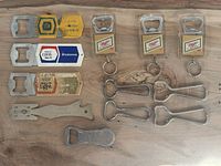 All 12 openers laid out on wood surface