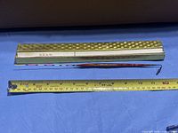 Float and box with tape measure showing length