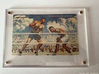 Front of postcard in acrylic mount showing boxing illustration