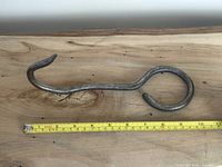 Full view of hay hook with tape showing length