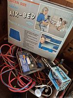 Entire lot with air bed box, compressor package, foot pump box, lamp and extension cords visible