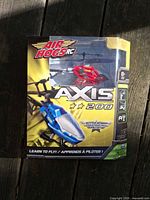 Front of sealed Axis 200 RC helicopter box showing contents and features