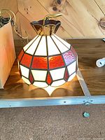 Lamp illuminated showing amber and white glass panels