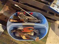 Blue tote with various hand tools visible