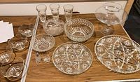 All sixteen glass pieces displayed