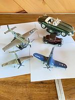 Group shot of three planes and two cars