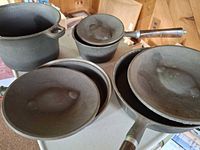 Group view of all four pans and three lids
