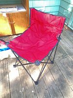 Red folding chair opened on deck