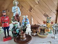 Assortment of figurines, vases, boxes, goblets displayed on surface