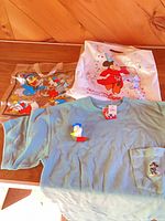All four Disney items laid out: Donald tote, night light, Mickey tee, anniversary bag