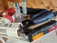 Group shot of flashlights and umbrellas on table