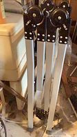 Ladder folded, showing black hinge joints and aluminum legs