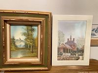 Both artwork pieces side by side on surface