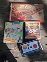 Group shot of four boxed games laid out together