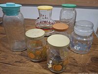 Group shot of all seven glass jars and bottles with lids