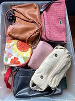 Top view of bin showing multiple bags and wallets