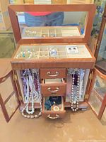Full view of jewelry box open with contents visible