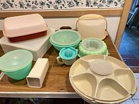 All items laid on table showing variety of Tupperware pieces