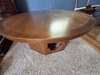 Top and part of base of round wood coffee table