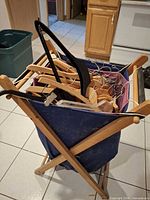Front angled view of hamper filled with various hangers