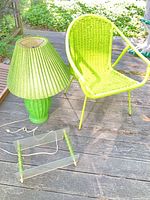 chair, lamp with shade, disassembled wall shelf on deck